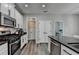 Bright kitchen featuring stainless steel appliances, black hardware, and granite countertops at 595 Stonepark Ln, Suwanee, GA 30024