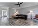 Cozy living room boasting a dark leather sofa, wood floors, and lots of natural light at 595 Stonepark Ln, Suwanee, GA 30024