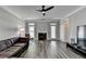 Inviting living room features a fireplace, a dark leather sofa, and lots of natural light at 595 Stonepark Ln, Suwanee, GA 30024