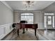 Sophisticated living space showcasing a grand piano, sleek flooring, and an inviting atmosphere at 595 Stonepark Ln, Suwanee, GA 30024