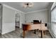 Elegant room featuring a beautiful grand piano, modern lighting, and classic architectural details at 595 Stonepark Ln, Suwanee, GA 30024