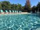 Sparkling community pool with comfortable lounge chairs and meticulously maintained landscaping at 595 Stonepark Ln, Suwanee, GA 30024