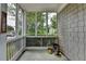 Enclosed porch featuring natural light, wooded views, and privacy at 595 Stonepark Ln, Suwanee, GA 30024
