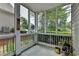 Enclosed porch featuring natural light, wooded views, and privacy at 595 Stonepark Ln, Suwanee, GA 30024