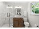Modern bathroom with marble walk-in shower, sleek vanity, and updated fixtures at 893 Vistavia Cir, Decatur, GA 30033
