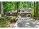 Charming two-story home with brick facade and a well-manicured front yard surrounded by lush greenery at 893 Vistavia Cir, Decatur, GA 30033