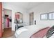 Inviting bedroom with crane motif wall, decorative mirror, and closet access at 989 Bibbs Circle Nw # 25, Atlanta, GA 30318