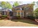 Lovely backyard featuring a spacious lawn, mulched flowerbeds, and a deck with french doors on the home's rear exterior at 1021 Oakpointe Pl, Dunwoody, GA 30338