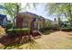 Backyard featuring a well-maintained lawn, mature landscaping, and a deck at 1021 Oakpointe Pl, Dunwoody, GA 30338