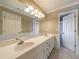 Bathroom featuring a large mirror, double sinks, and neutral tile at 1021 Oakpointe Pl, Dunwoody, GA 30338