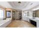 Luxurious bathroom with soaking tub, glass-enclosed shower, and travertine flooring, designed for relaxation at 1021 Oakpointe Pl, Dunwoody, GA 30338