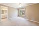 Neutral bedroom features a large window, light carpet, and an en-suite bathroom at 1021 Oakpointe Pl, Dunwoody, GA 30338