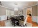 Formal dining room with elegant chandelier and views of the living spaces at 1021 Oakpointe Pl, Dunwoody, GA 30338