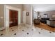 Bright foyer with tile flooring, leading to a living area with a dark wood door and white trim at 1021 Oakpointe Pl, Dunwoody, GA 30338