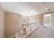 Upstairs hallway with hardwood floors, chandelier, and view of front door from the top of stairs at 1021 Oakpointe Pl, Dunwoody, GA 30338
