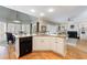 Open kitchen featuring an island with granite countertops and stainless steel appliances at 1021 Oakpointe Pl, Dunwoody, GA 30338
