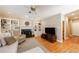 Living room with built-in shelving, fireplace, hardwood floors, and large windows at 1021 Oakpointe Pl, Dunwoody, GA 30338