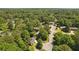 Aerial view featuring the house situated within a tree-lined neighborhood and manicured lawns at 1850 Linnet Ne Ct, Roswell, GA 30075