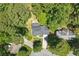 Aerial view of a house with a long driveway and a wooden deck surrounded by trees at 1850 Linnet Ne Ct, Roswell, GA 30075