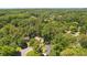 Aerial view showcases home nestled within a lush, tree-filled neighborhood at 1850 Linnet Ne Ct, Roswell, GA 30075