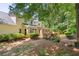 Exterior of the house featuring a wooden deck, beautiful landscaping, and mature trees at 1850 Linnet Ne Ct, Roswell, GA 30075