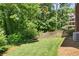 Lush backyard with mature trees, green grass, and privacy fencing at 1850 Linnet Ne Ct, Roswell, GA 30075