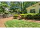 Well-manicured backyard featuring lush lawn, wood fencing, and mature trees at 1850 Linnet Ne Ct, Roswell, GA 30075