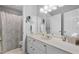 Well-lit bathroom with a wide mirror, neutral tones, and ample vanity storage at 1850 Linnet Ne Ct, Roswell, GA 30075