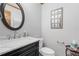 Stylish half bathroom features a modern vanity with granite countertop at 1850 Linnet Ne Ct, Roswell, GA 30075