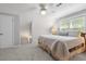 Cozy bedroom featuring a bed with decorative pillows, carpet, and natural light at 1850 Linnet Ne Ct, Roswell, GA 30075