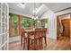 A brightly lit dining area features skylights, plants, and large windows overlooking the backyard at 1850 Linnet Ne Ct, Roswell, GA 30075