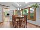 A dining area includes a table for six, skylights and a view of a deck and back yard at 1850 Linnet Ne Ct, Roswell, GA 30075