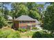 Charming brick home with a manicured lawn, inviting entrance, and three-car garage at 1850 Linnet Ne Ct, Roswell, GA 30075