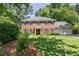 Charming two-story brick home features a well-manicured lawn, mature trees, and a three-car garage at 1850 Linnet Ne Ct, Roswell, GA 30075