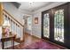 Elegant foyer features hardwood floors, an iron door, and white wainscoting at 1850 Linnet Ne Ct, Roswell, GA 30075