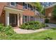 The front of the property features manicured landscaping, an iron door, and a three-car garage at 1850 Linnet Ne Ct, Roswell, GA 30075
