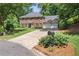 Charming two-story brick home with a three-car garage, well-maintained lawn, and landscaped front yard at 1850 Linnet Ne Ct, Roswell, GA 30075