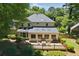 Home featuring a large wooden deck, large windows, and well-maintained backyard at 1850 Linnet Ne Ct, Roswell, GA 30075