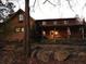 Inviting rustic log home featuring a cozy front porch and a beautifully wooded setting at 6965 Flowery Branch Rd, Cumming, GA 30041