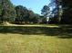 Expansive grassy yard with mature trees offering ample space and natural beauty at 6965 Flowery Branch Rd, Cumming, GA 30041