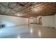Spacious unfinished basement featuring a stone accent, painted floor, and exposed ceiling at 2174 Kinridge Rd, Marietta, GA 30062