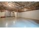 Large, unfinished basement with painted floors, stone accent, and exposed ceiling at 2174 Kinridge Rd, Marietta, GA 30062
