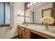 Bright bathroom with a marble countertop, a vanity mirror and window with blinds at 2174 Kinridge Rd, Marietta, GA 30062