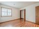 Bedroom featuring laminate wood flooring, a closet and a window providing natural light at 2174 Kinridge Rd, Marietta, GA 30062