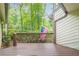 Exterior shot of a wooden deck with view of American flag surrounded by lush greenery, offering a serene outdoor space at 2174 Kinridge Rd, Marietta, GA 30062
