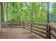 View of a wooden deck with railing showcasing the surrounding trees and greenery at 2174 Kinridge Rd, Marietta, GA 30062