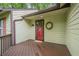 Inviting front porch features a red door, wooden deck, and charming wreath decor at 2174 Kinridge Rd, Marietta, GA 30062
