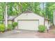Garage and driveway surrounded by lush greenery, offering a private and serene setting at 2174 Kinridge Rd, Marietta, GA 30062
