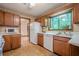 Cozy kitchen features wood cabinets and a window with a view of the trees at 2174 Kinridge Rd, Marietta, GA 30062