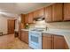 Traditional kitchen featuring wood cabinets, white countertops, and a white gas range stove at 2174 Kinridge Rd, Marietta, GA 30062